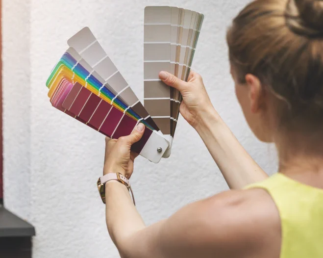 woman choosing paint color for residential exterior